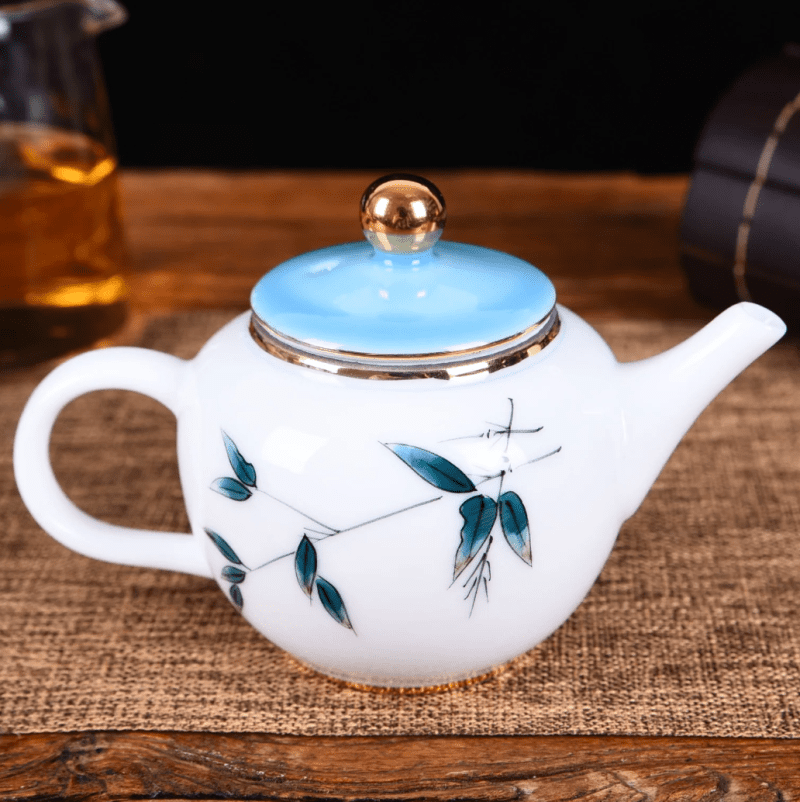 whiteporcelainbluebamboohand paintedteapot 1